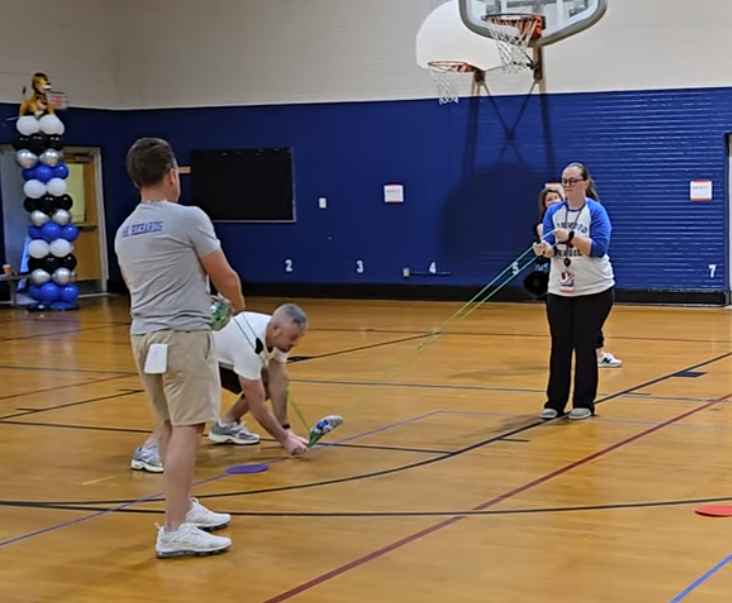 Staff members playing game in gymnasium