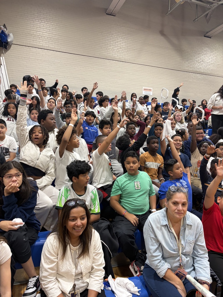 Students cheering  in gym at a pep rally