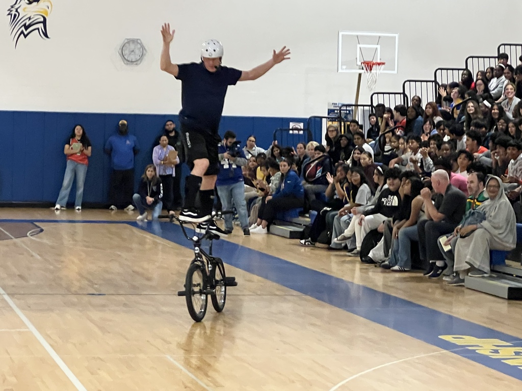Bicyclist standing on seat and riding