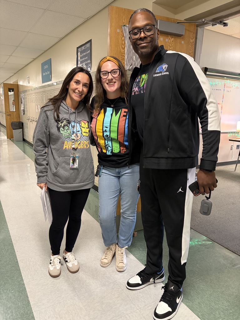 Teachers posed together in hallway