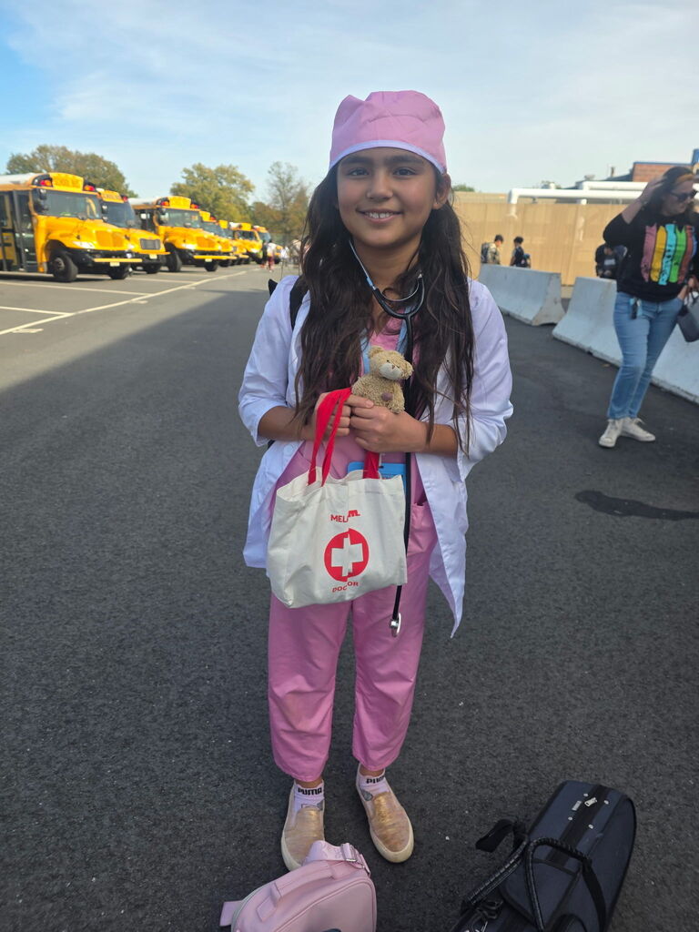 Student posing in costume in parking lot