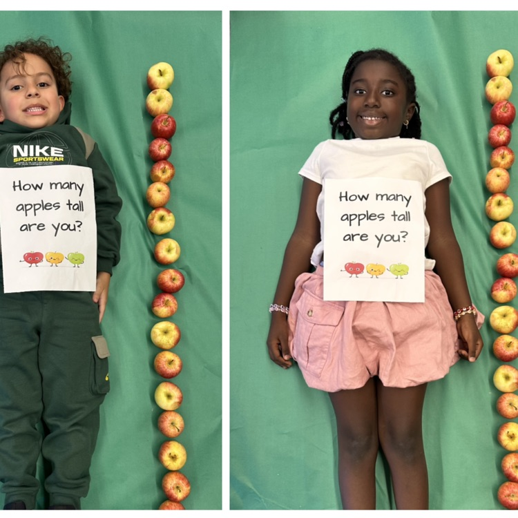 Kids laying next to a stack of apples