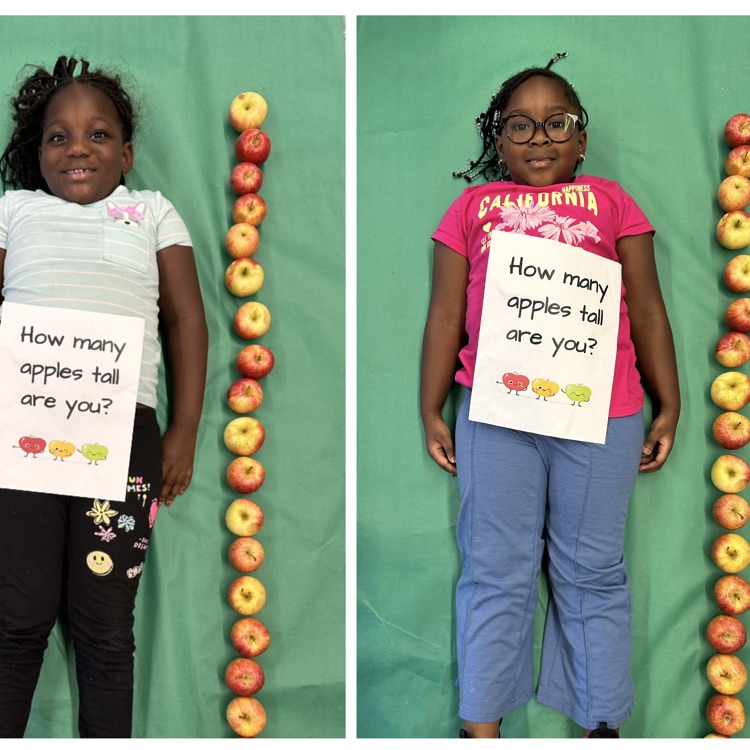 Kids laying next to a stack of apples