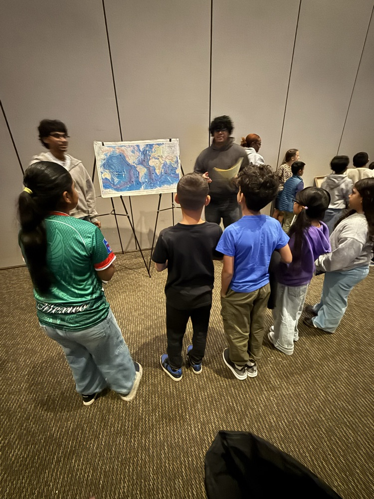 Students listening together to older students
