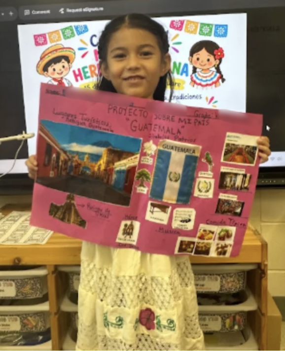 Student holding up project on Guatemala
