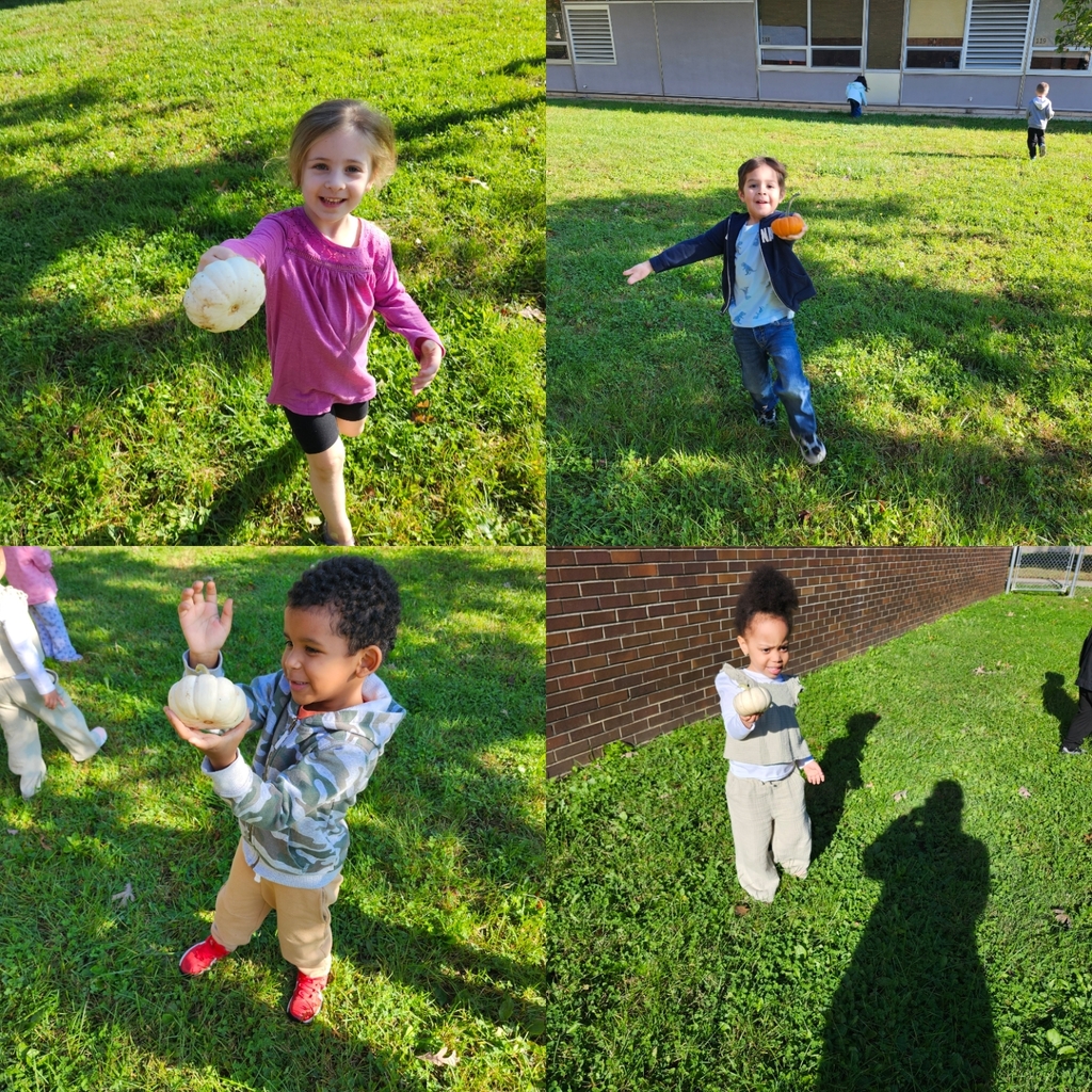 Students holding up Pumpkins