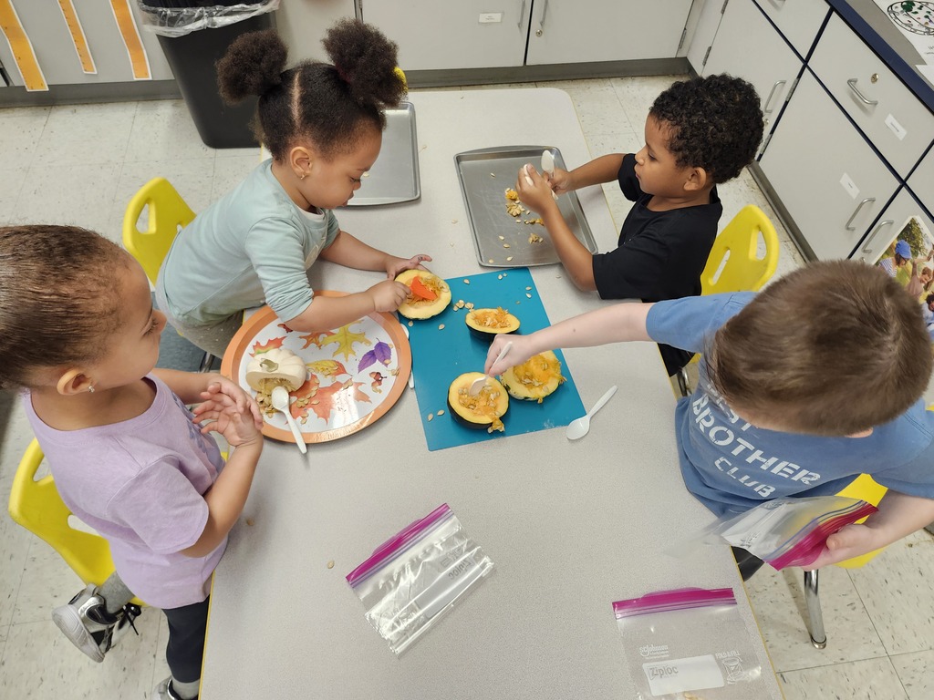 Students sitting at a table doing a Pumpkin pulp activity