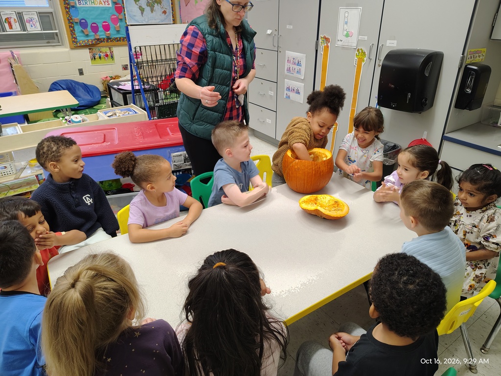 Students sitting at a table doing a Pumpkin Discovery activity