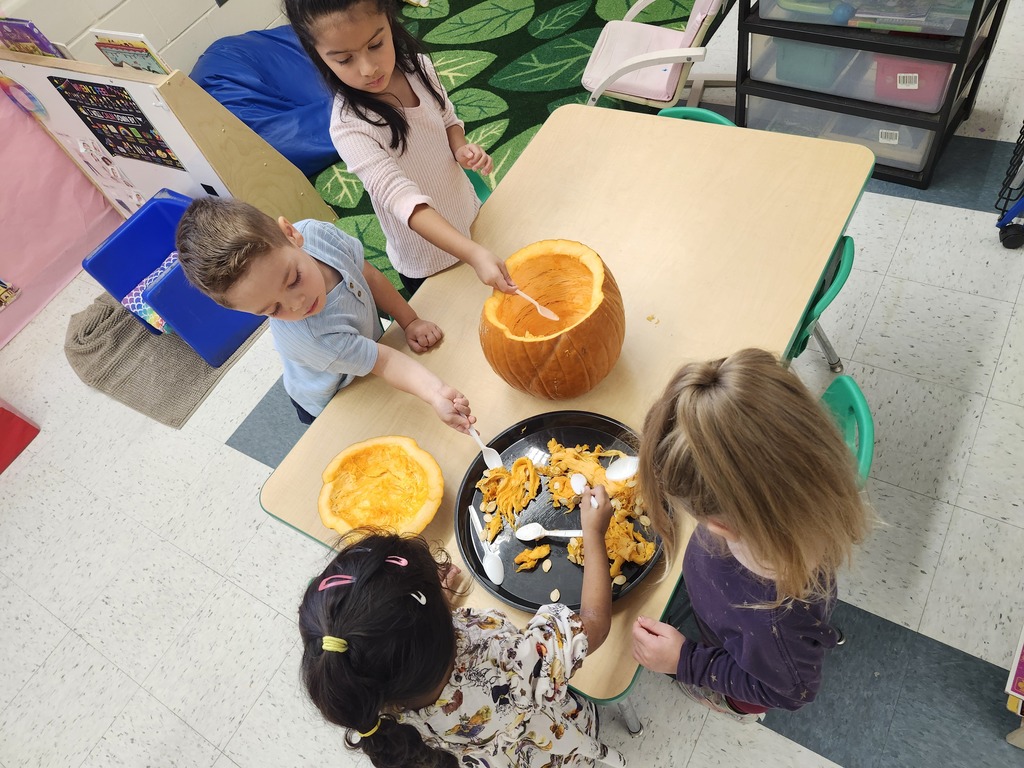 Students sitting at a table doing a Pumpkin pulp activity