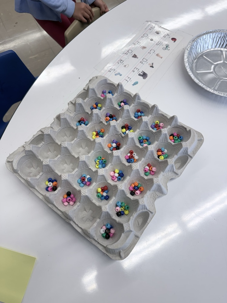 Students counting items into egg crates