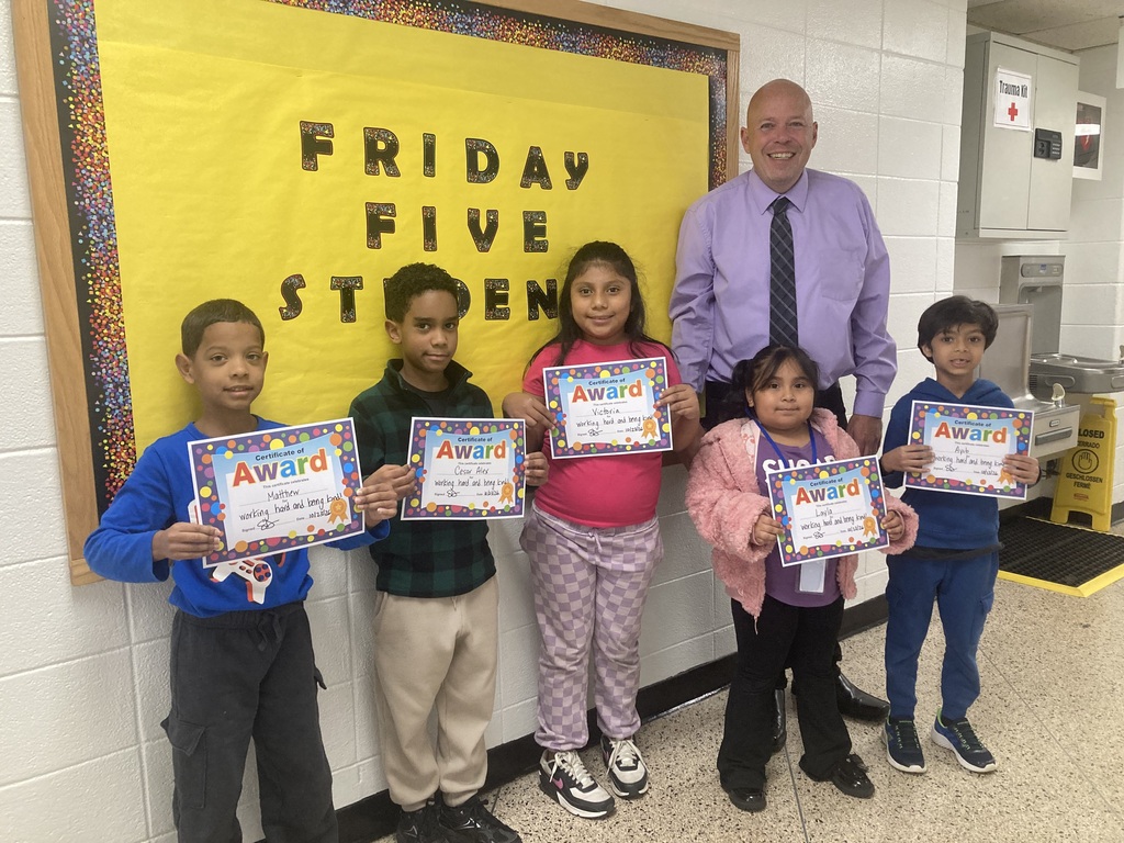 Principal standing with a group of five students with certificates
