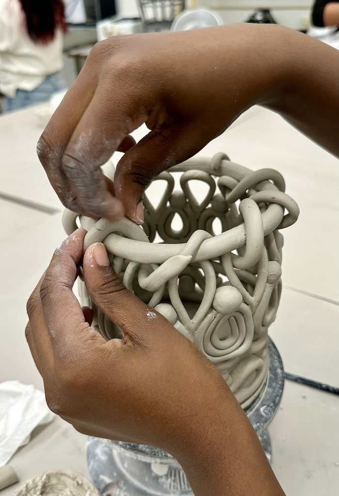 Student making ceramic artwork