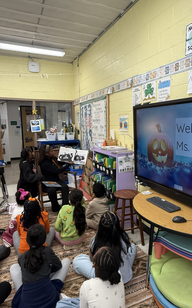 parent reading to a class of students