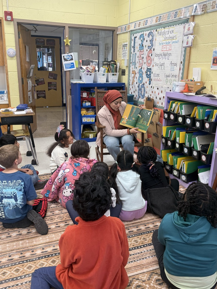 parent guest reader  reading to kids on carpet
