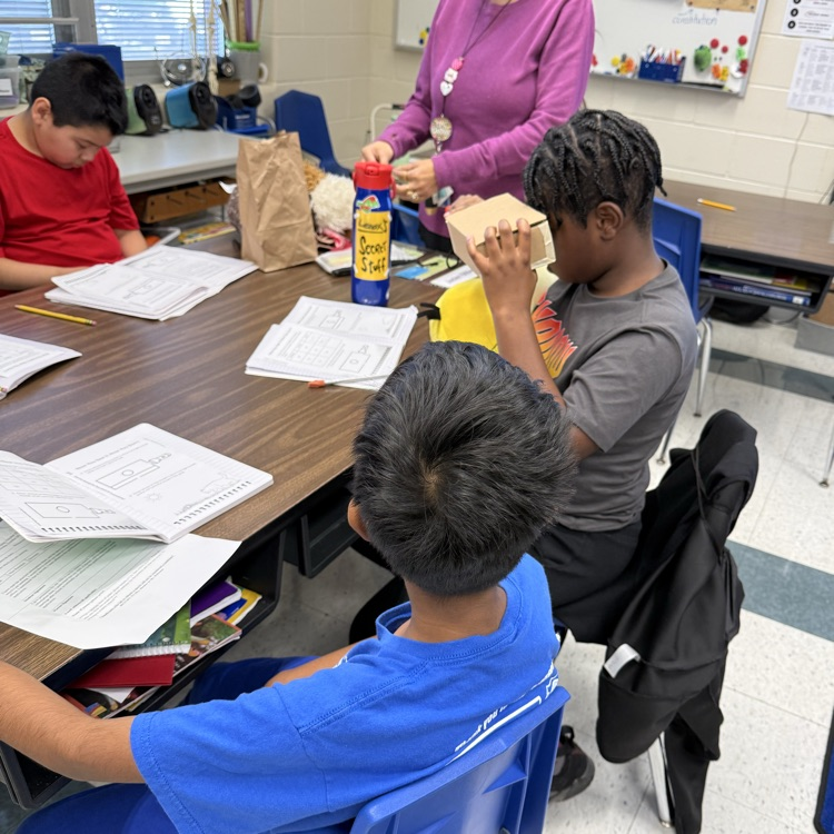 Students at tables doing a science experiment