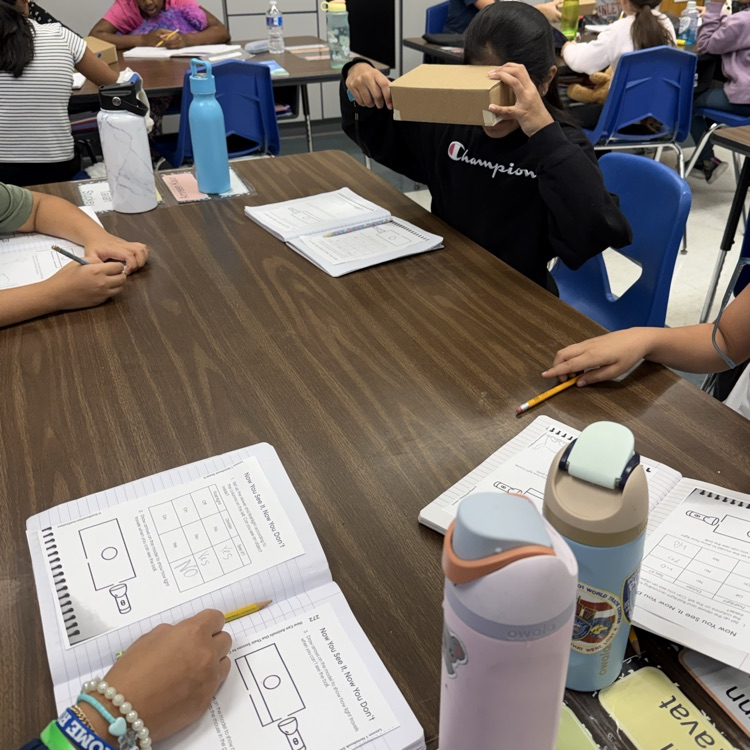 Students at tables doing a science experiment