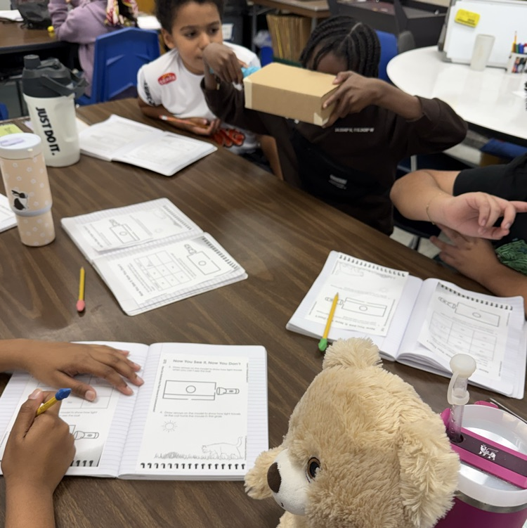 Students at tables doing a science experiment