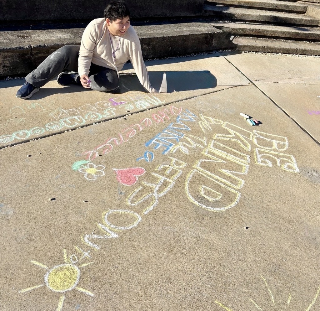 students making positive messages in chalk