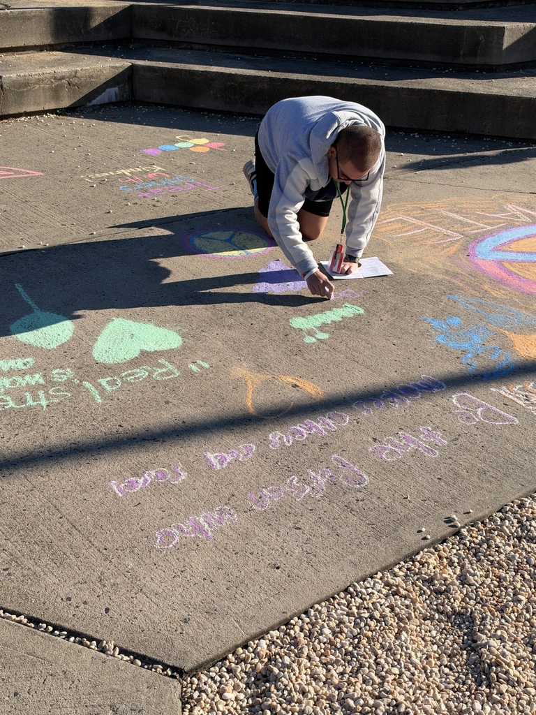 students making positive messages in chalk