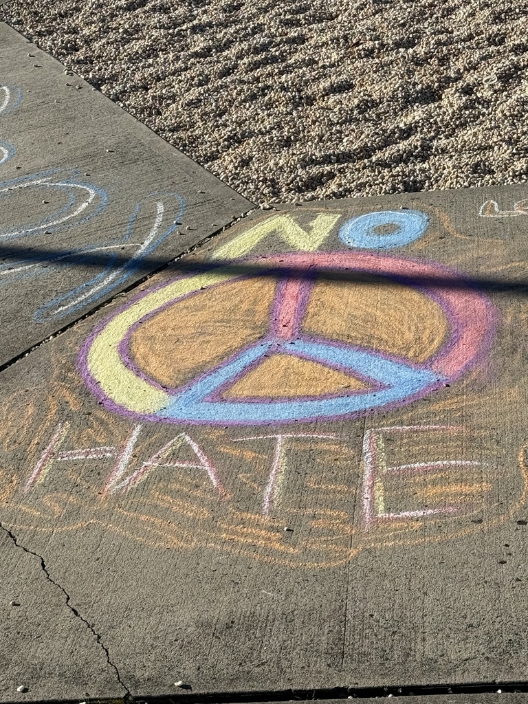students making positive messages in chalk