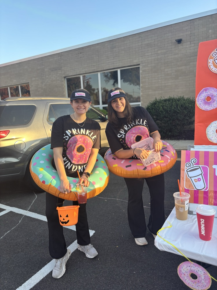staff in halloween costumes at school event outside