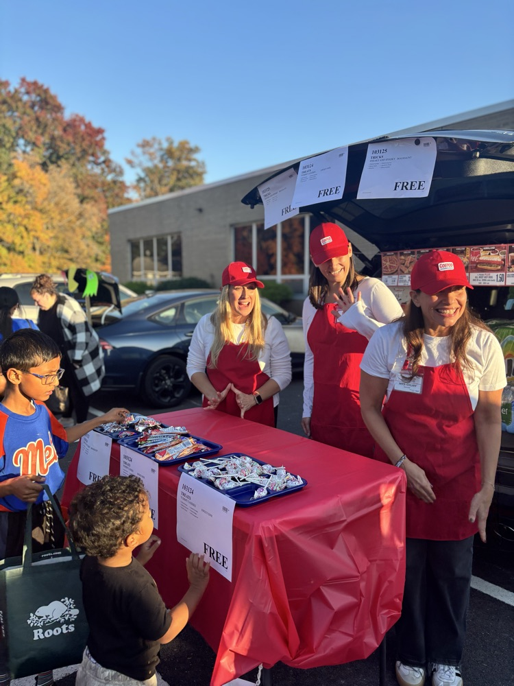 staff in halloween costumes at school event outside