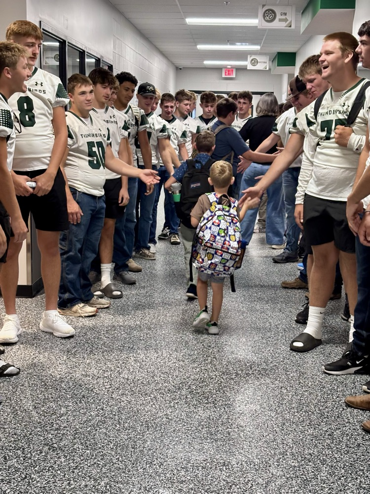 NC Football team greeting NCES students