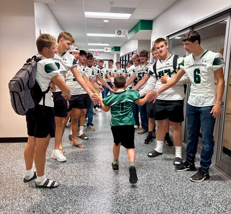 NC Football team greeting NCES students