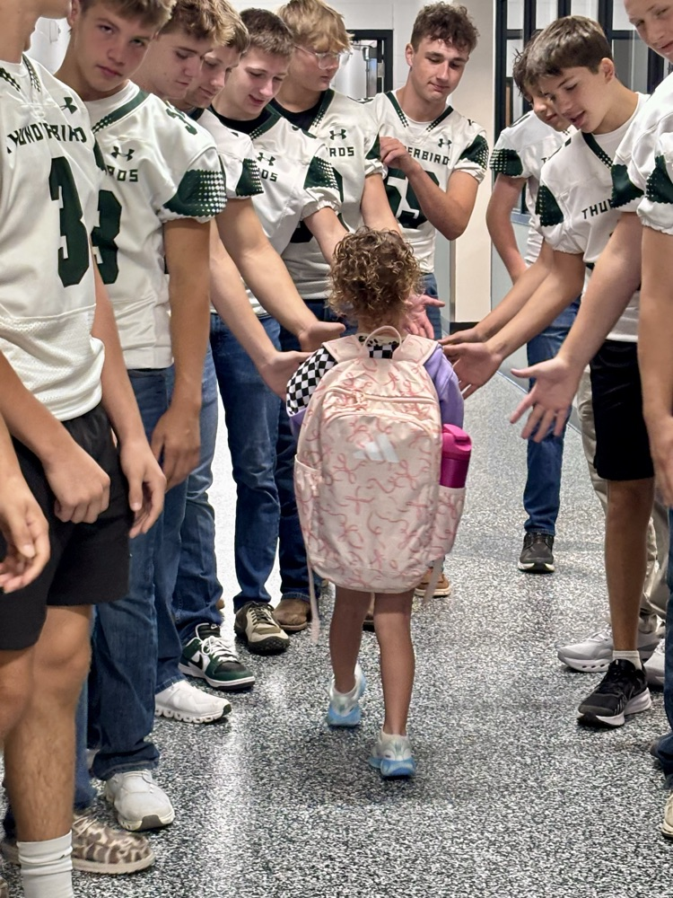NC Football team greeting NCES students
