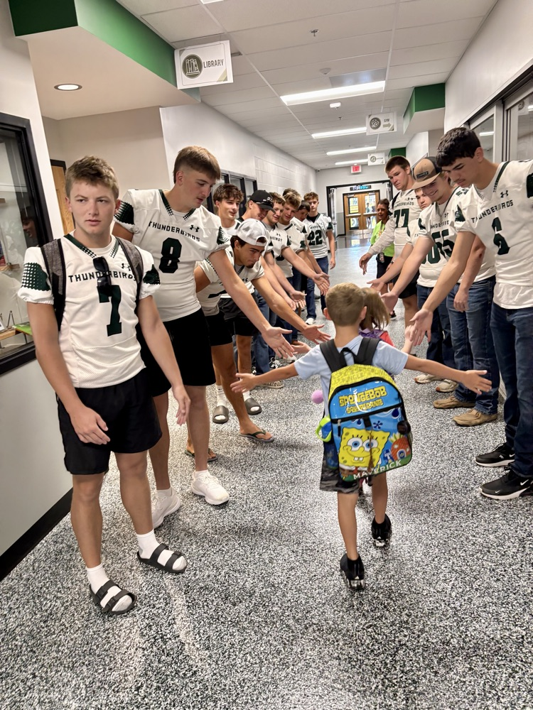 NC Football team greeting NCES students