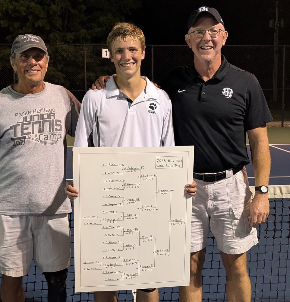 three men standing together with the one in the middle holding a tennis tournament card