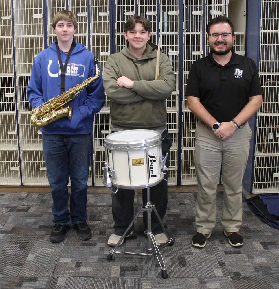 two band members with their instruments and the band directro