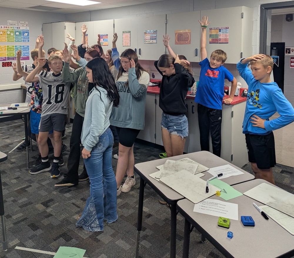 students in a classroom participating in a math review activity