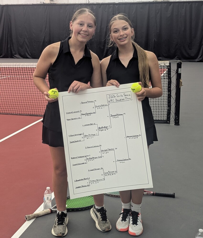 two tennis players holding tennis balls and score cards