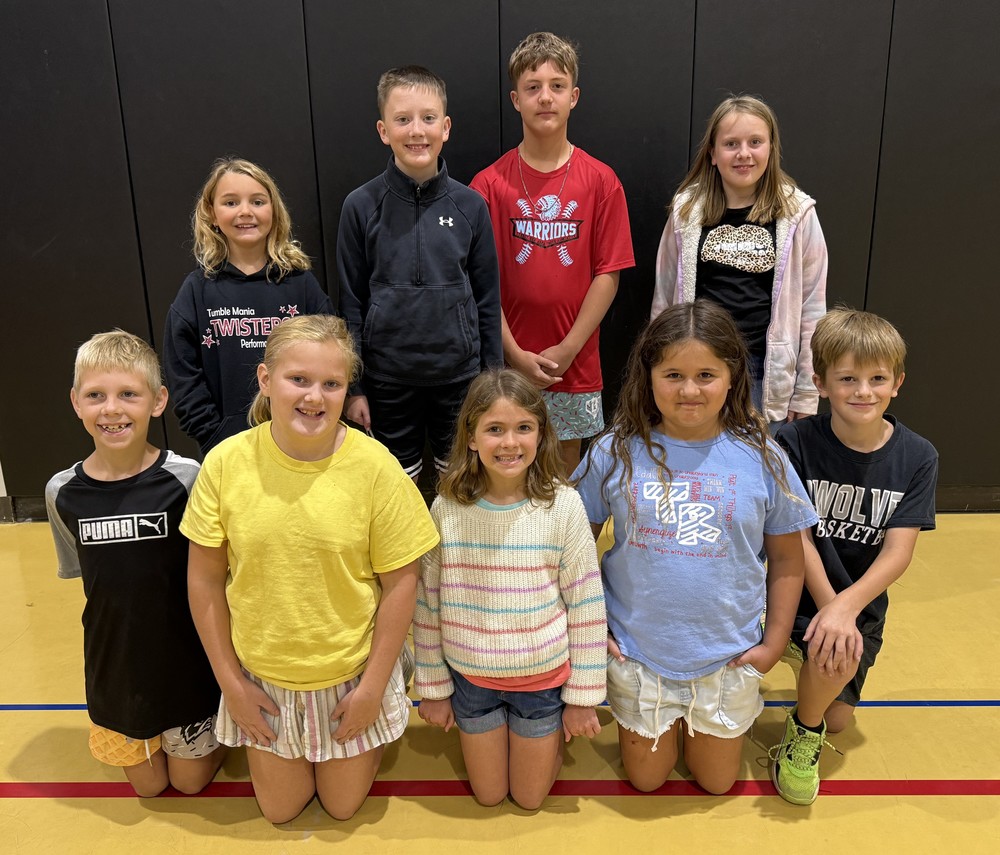 students kneeling or standing in rows