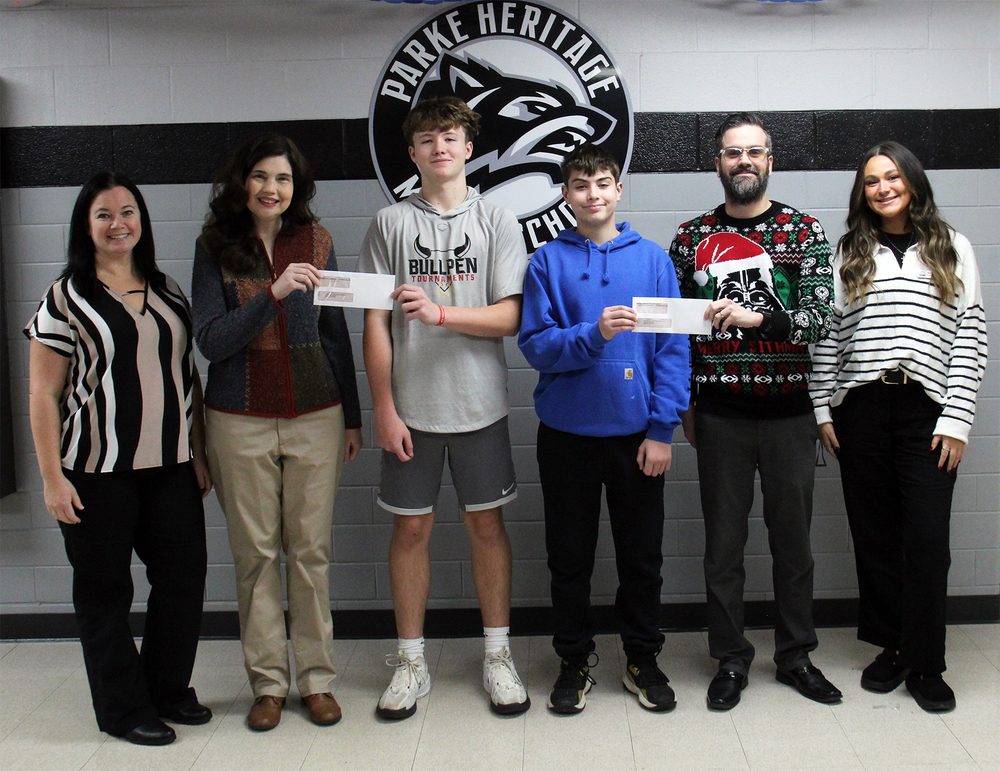 six people standing in a row with two teachers receiving checks