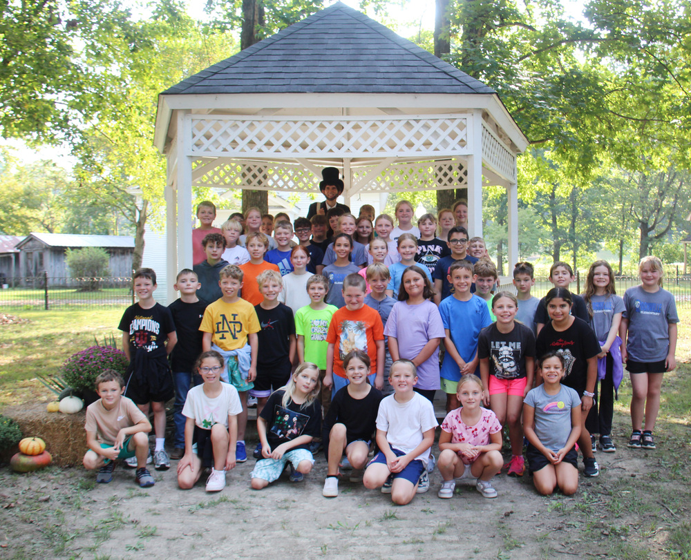 RES 4th Grade posing for a photo at the gazebo in Billie Creek Village with Abraham Lincoln.