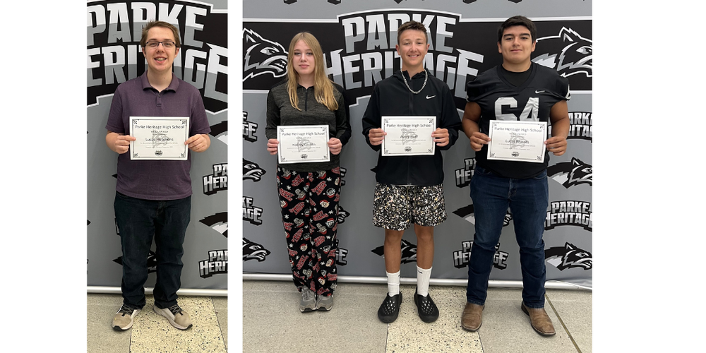 four students standing in front of the Parke Heritage backdrop holding a certificate