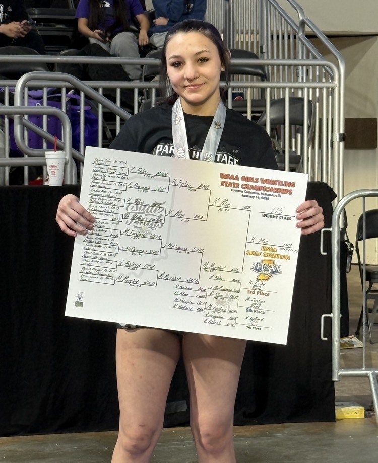 photo of wrestler holding a score card