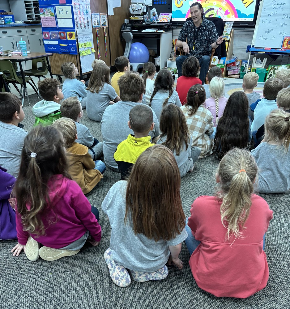 group of students sitting and listening to a guest speaker