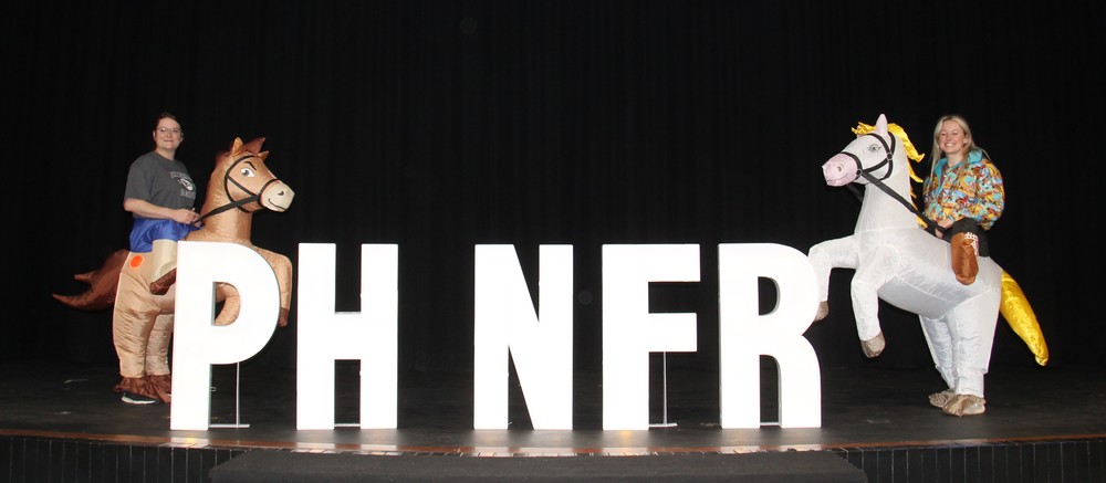 photo with two teachers in horse costumes and the letters PH NFR