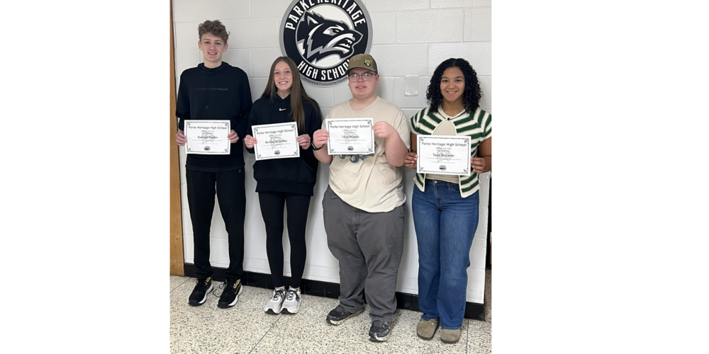 photo with four students standing in a line holding certificates