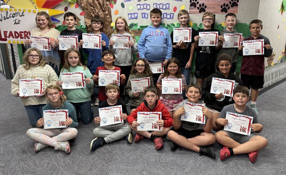 students sitting, kneeling and standing and holding certificates