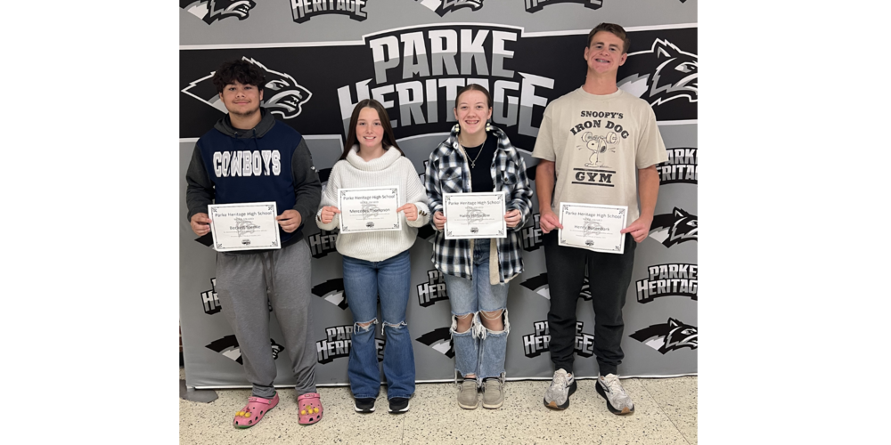 fourt students standing in front of a backdrop holding certificates