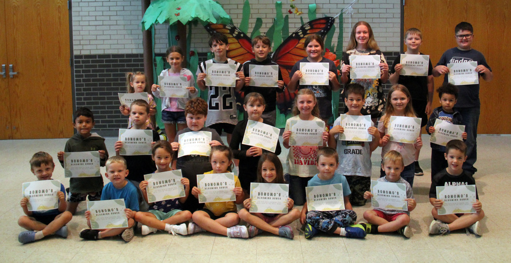 three rows of students sitting, kneeling or standing while holding certificates for Bonomo's Blooming Bunch