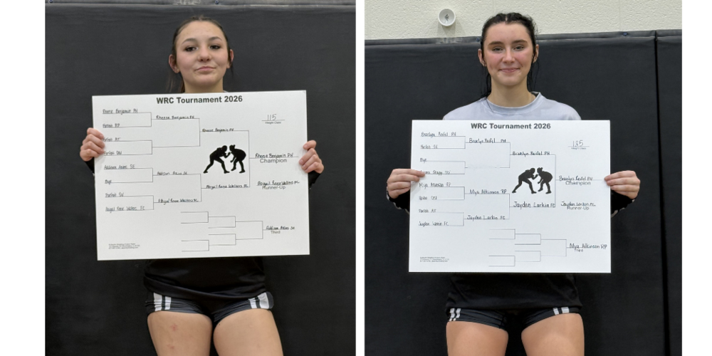 two girls wrestlers holding their Conference cards