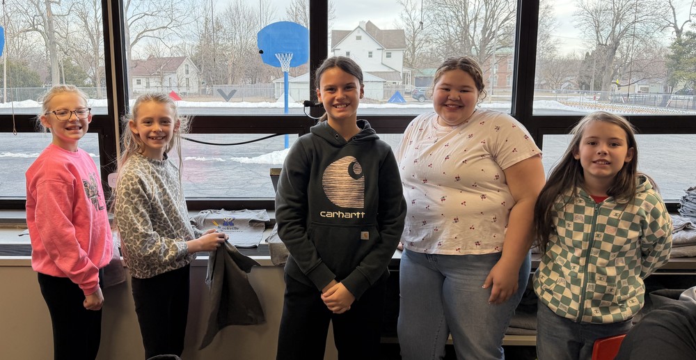 five girls standing in a line by the art room windows