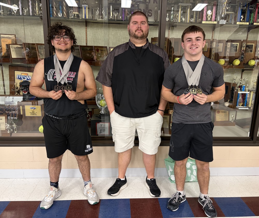 three men standing in a line with two of them wearing medals