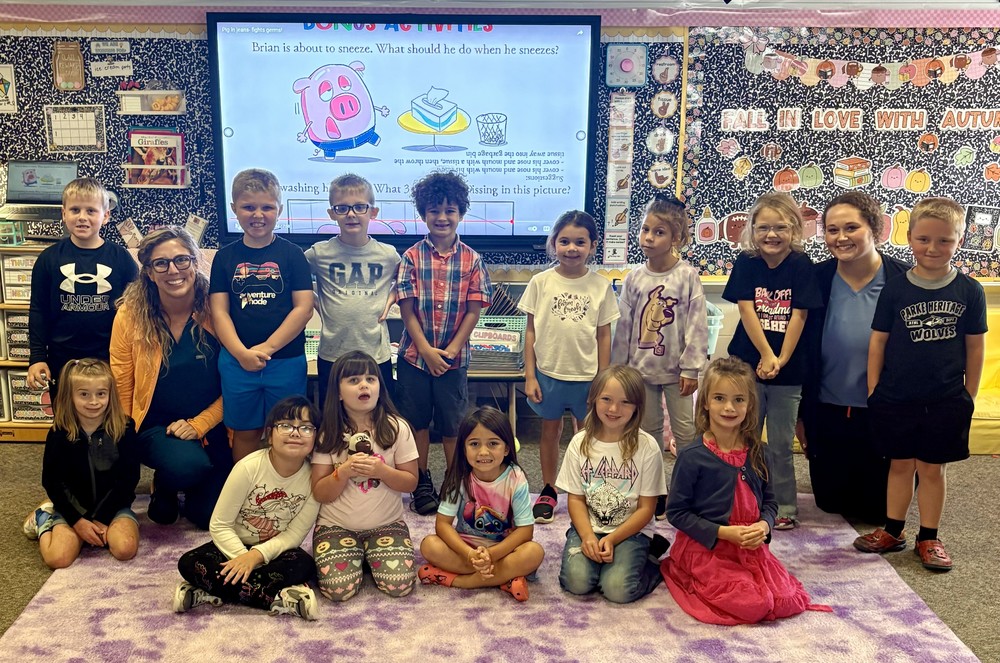 students with two nurses sitting and standing in rows