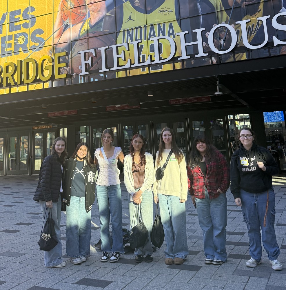 seven girls standing in front of Gainbridge Fieldhouse